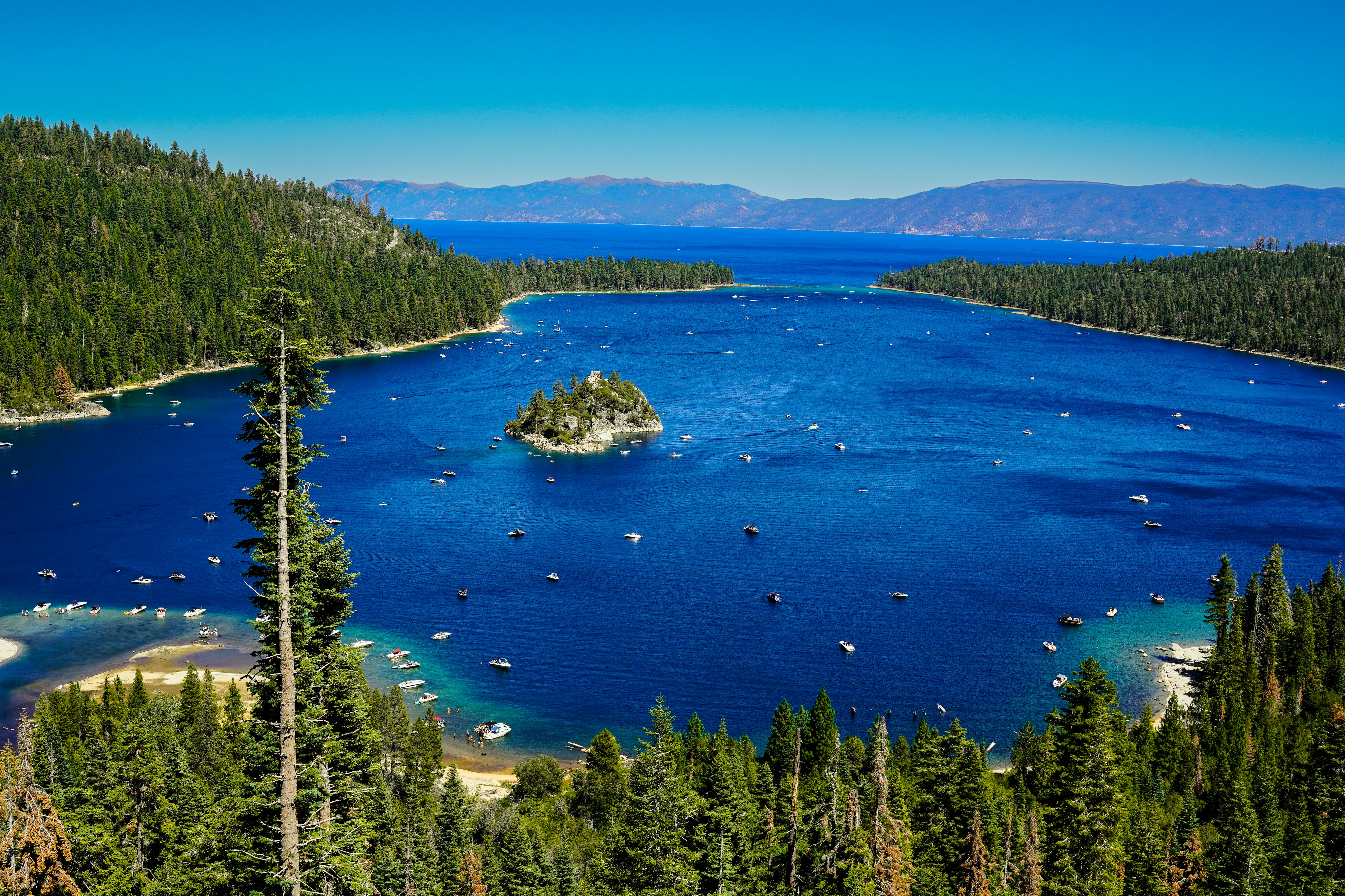 Lake Tahoe turquoise water in summer with pine trees and mountains